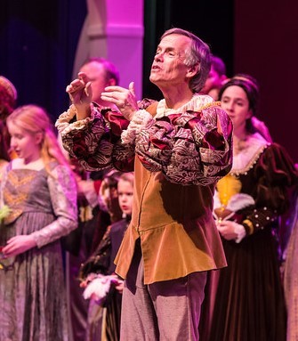Robert Lockwood leads the audience in a sing along in the 2018 production of Midwinter Revels, Nordic Lights.