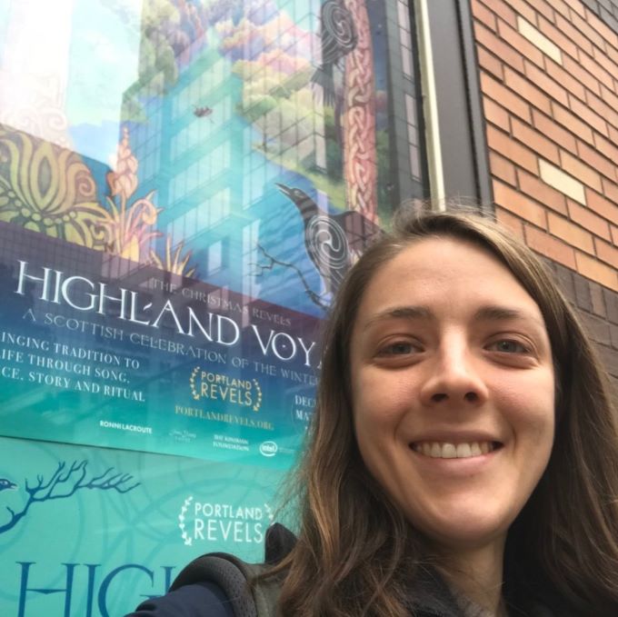 Leslie Moclock in front of the 2018 show poster